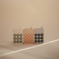 Mushie pop it phone blush 10 months +