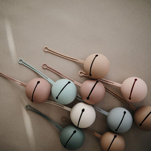 Mushie pacifier holder sand