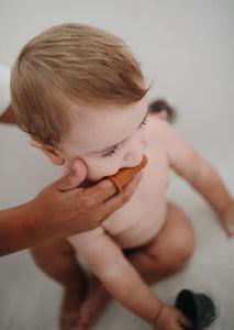 Mushie baby toothbrush sand blush