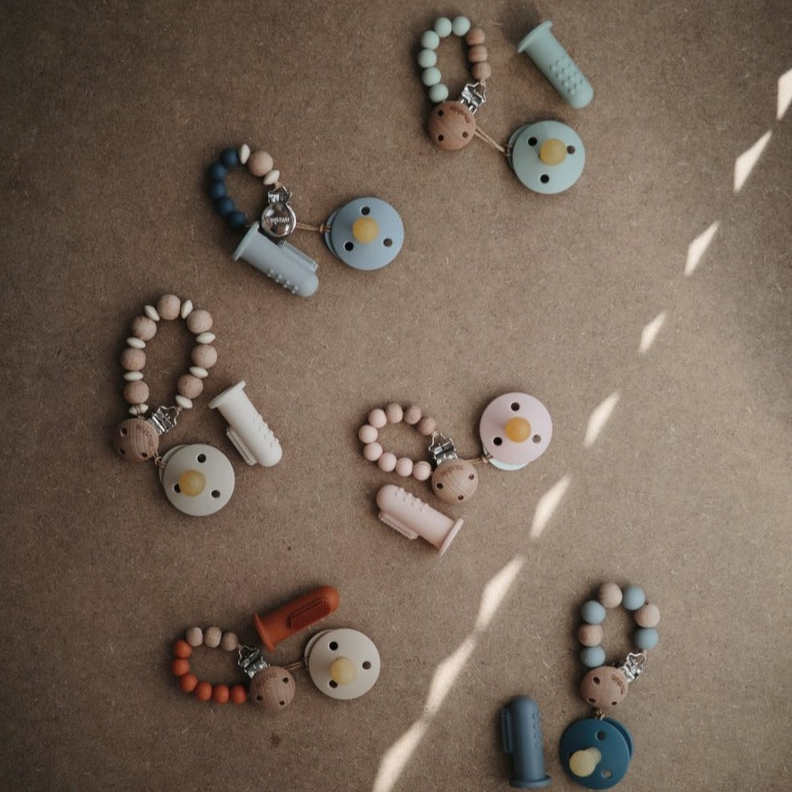 Mushie baby toothbrush sand clay