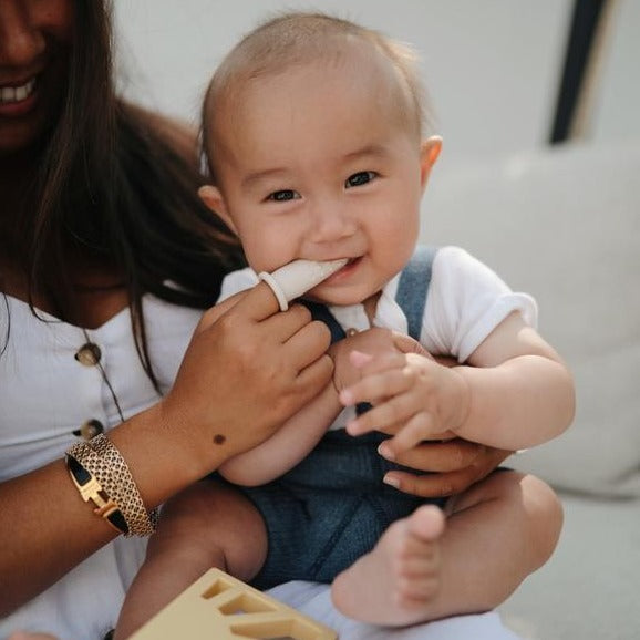 Mushie baby toothbrush sand clay